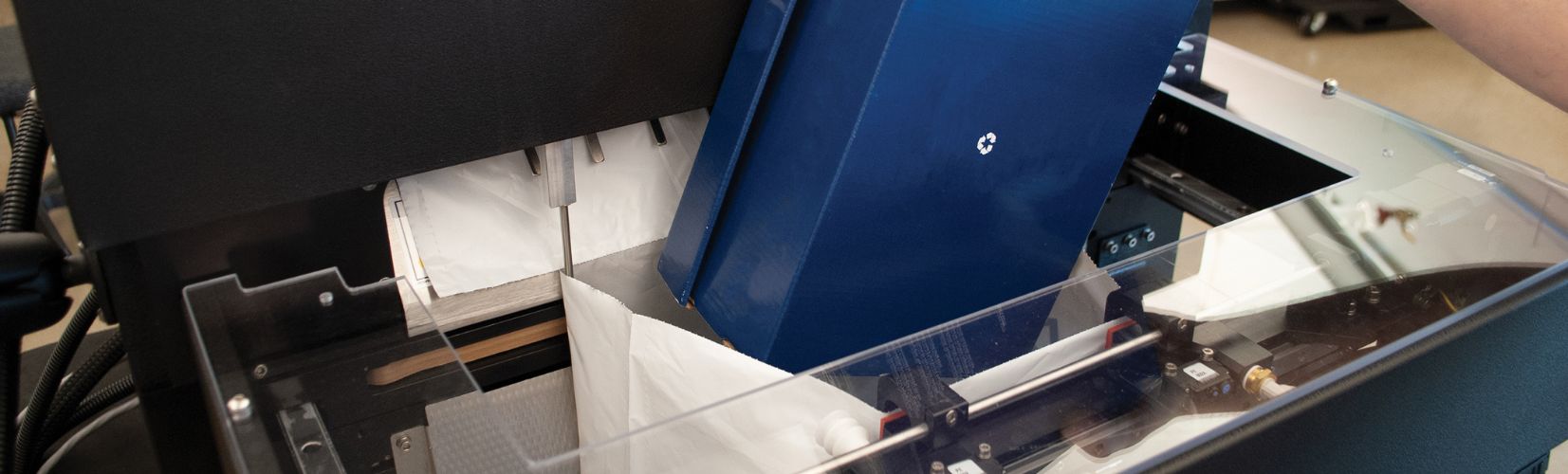 Automated Bagger packing up navy blue shoebox